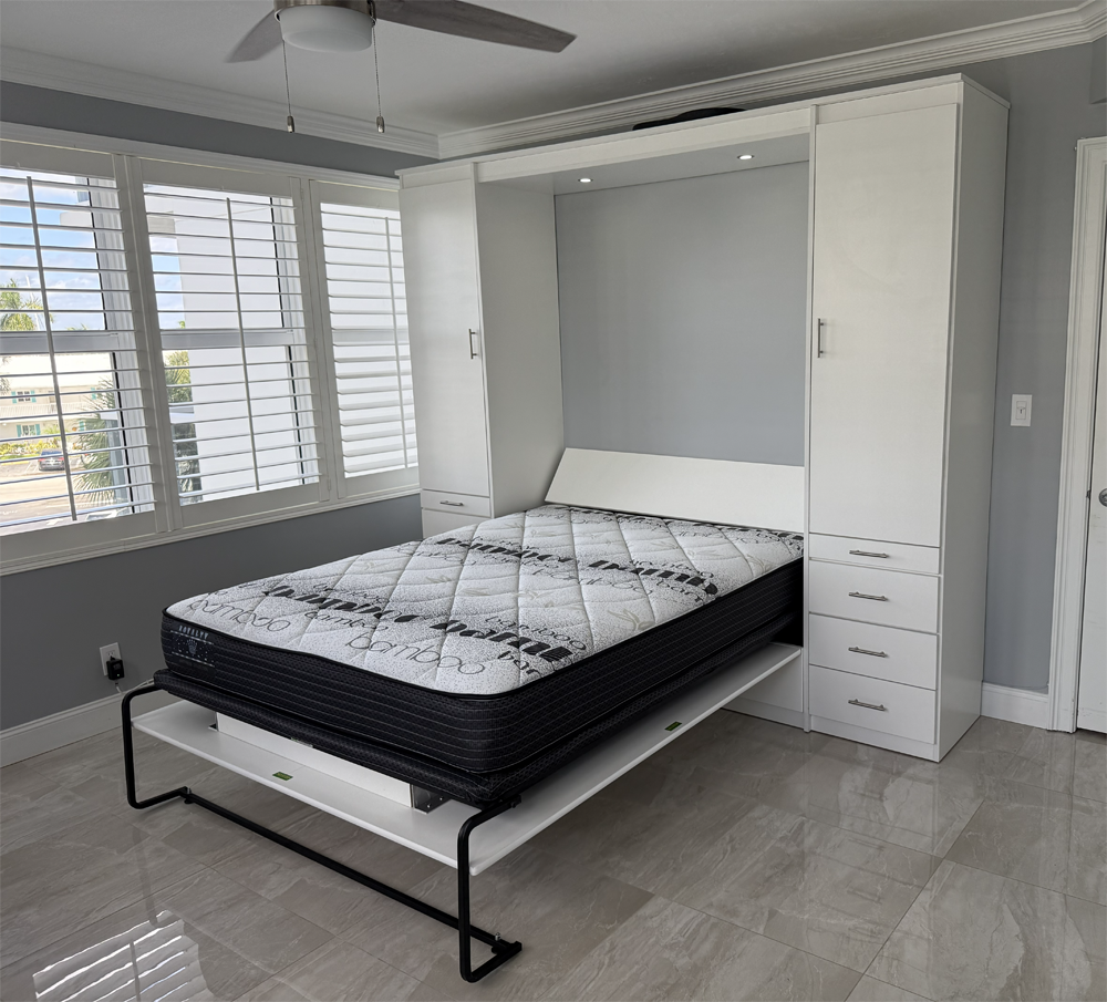 Custom white Murphy bed with cabinetry installed in South Florida