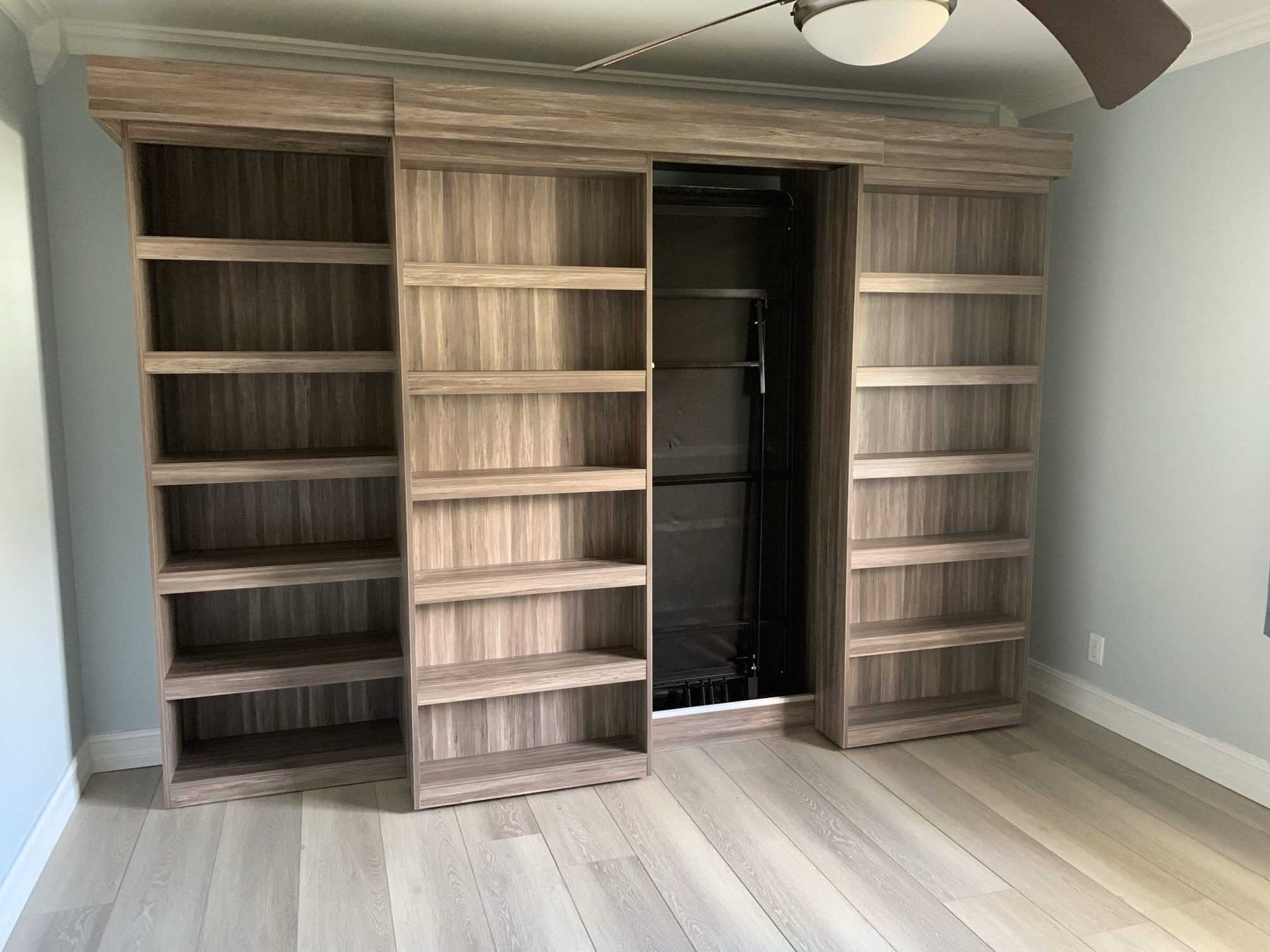 Murphy bed with shelving and cabinetry built in South Florida